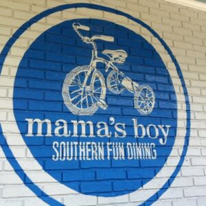 Blue and white logo on a white brick wall